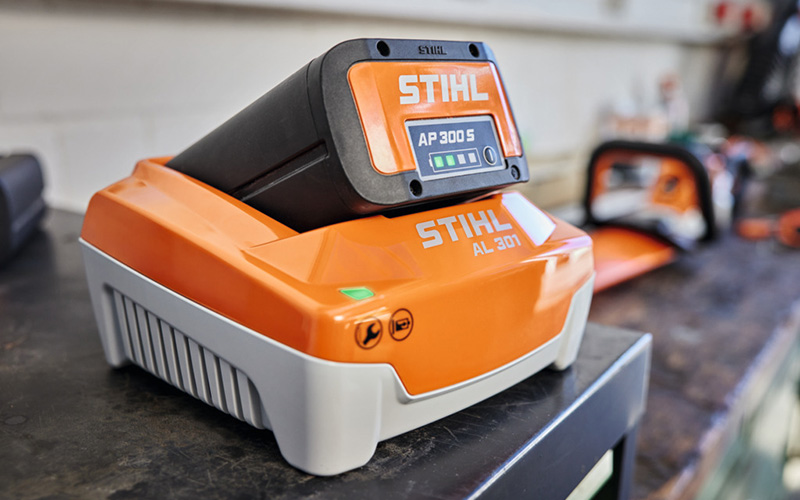 STIHL AP Battery and charger on top a workbench